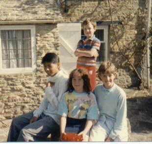Brian with Scott, Emylee and Teayre on front of a British cottage in England