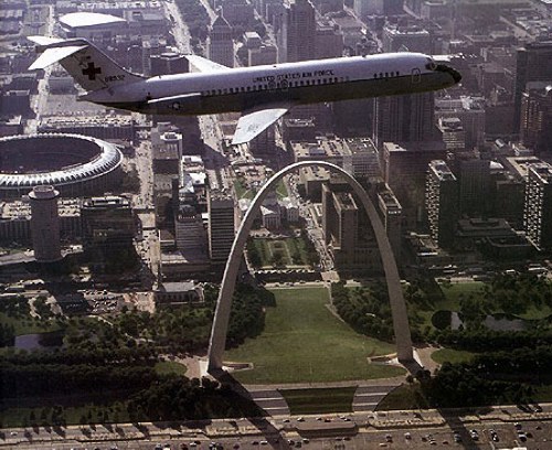 Air Force C-9 flying over the Gateway Arch