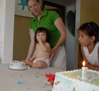 Landon eating his own personal cake with mom, Gina and his cousin,Tiarra Paige watching